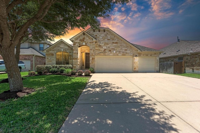 1803 Valle Verde Dr, Cedar Park, TX 78641 - french country style house with concrete driveway, an attached garage, and stone siding