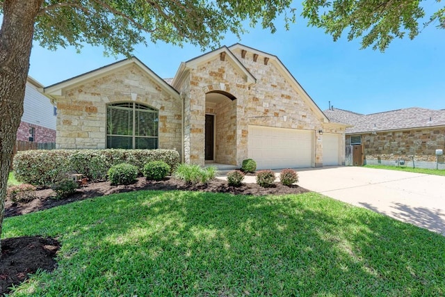 1803 Valle Verde Dr, Cedar Park, TX 78641 - french country inspired facade with an attached garage, concrete driveway, and stone siding
