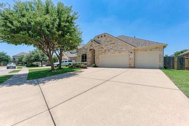 1803 Valle Verde Dr, Cedar Park, TX 78641 - french provincial home with a garage, concrete driveway, and stone siding