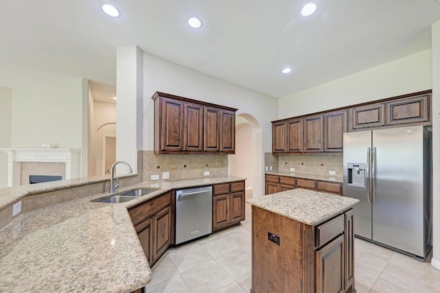 1803 Valle Verde Dr, Cedar Park, TX 78641 - kitchen featuring appliances with stainless steel finishes, a sink, light stone counters, tasteful backsplash, and recessed lighting