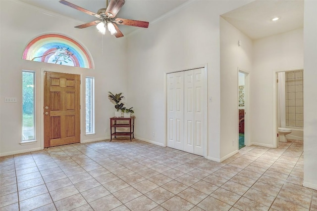 900 Cedar Park Dr, Cedar Park, TX 78613 - entrance foyer featuring a towering ceiling, light tile patterned flooring, a ceiling fan, baseboards, and crown molding