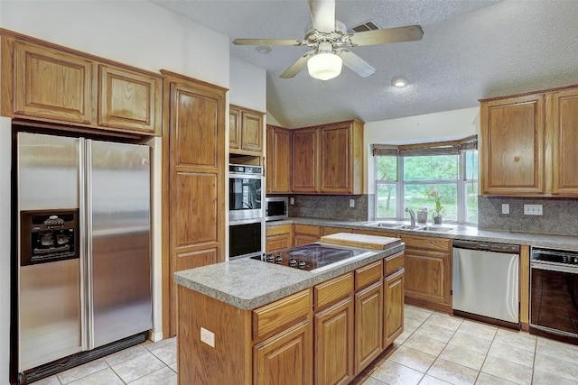 900 Cedar Park Dr, Cedar Park, TX 78613 - kitchen with appliances with stainless steel finishes, a sink, tasteful backsplash, light tile patterned floors, and vaulted ceiling