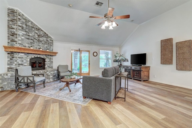 900 Cedar Park Dr, Cedar Park, TX 78613 - living room featuring light wood-type flooring, a fireplace, a ceiling fan, baseboards, and high vaulted ceiling