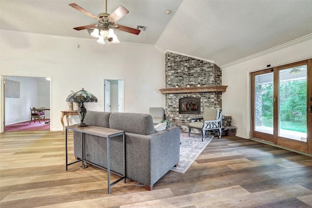 900 Cedar Park Dr, Cedar Park, TX 78613 - living area with ornamental molding, light wood-style flooring, lofted ceiling, a fireplace, and a ceiling fan