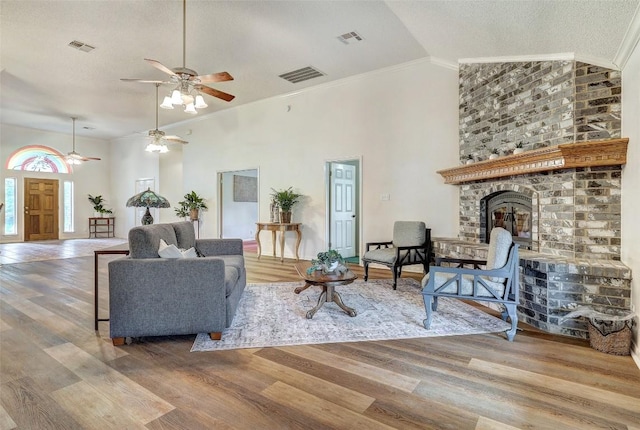 900 Cedar Park Dr, Cedar Park, TX 78613 - living room featuring ceiling fan, a brick fireplace, high vaulted ceiling, wood finished floors, and ornamental molding