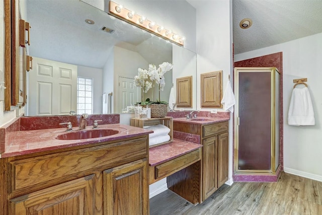 900 Cedar Park Dr, Cedar Park, TX 78613 - bathroom with vaulted ceiling, a shower stall, vanity, wood finished floors, and baseboards