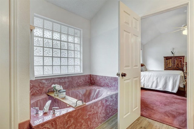 900 Cedar Park Dr, Cedar Park, TX 78613 - bathroom with ensuite bathroom, wood finished floors, a garden tub, ceiling fan, and lofted ceiling