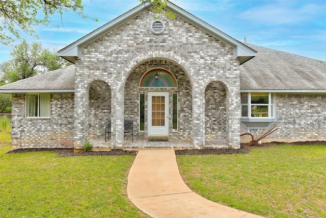 900 Cedar Park Dr, Cedar Park, TX 78613 - view of front of house with brick siding, a front lawn, and roof with shingles