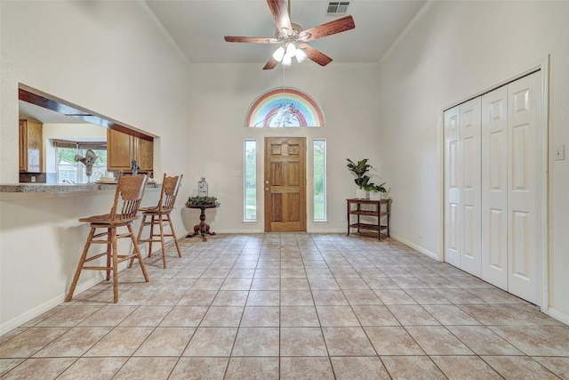 900 Cedar Park Dr, Cedar Park, TX 78613 - foyer entrance featuring plenty of natural light, a towering ceiling, crown molding, ceiling fan, and light tile patterned floors