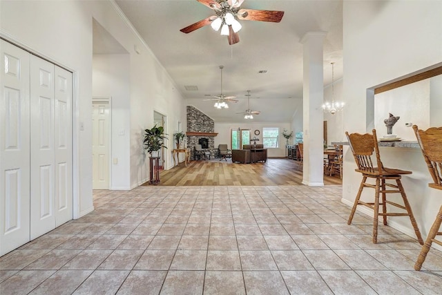 900 Cedar Park Dr, Cedar Park, TX 78613 - entryway with a ceiling fan, light tile patterned flooring, a fireplace, a chandelier, and high vaulted ceiling
