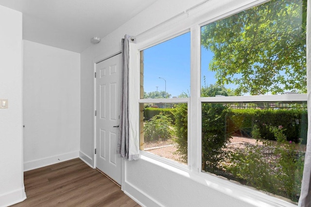 1101 Grove Blvd Unit 803, Austin, TX 78741 - spare room with wood finished floors, baseboards, healthy amount of natural light, and a smoke detector