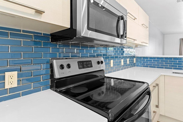 1101 Grove Blvd Unit 803, Austin, TX 78741 - kitchen with stainless steel appliances, decorative backsplash, light countertops, and white cabinetry