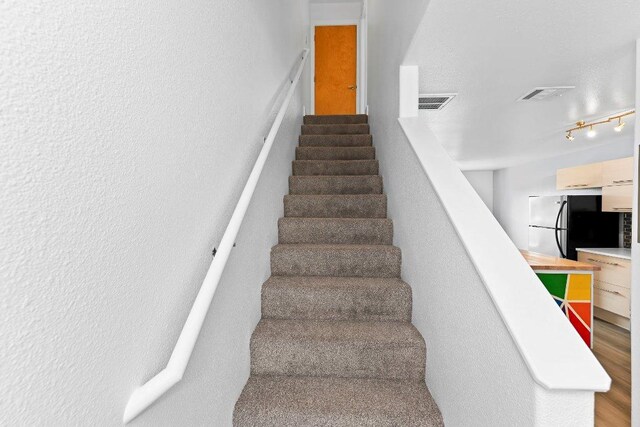 1101 Grove Blvd Unit 803, Austin, TX 78741 - stairway featuring wood finished floors
