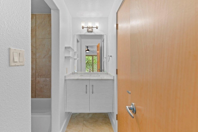1101 Grove Blvd Unit 803, Austin, TX 78741 - full bathroom with vanity, tile patterned flooring, a shower, baseboards, and a ceiling fan