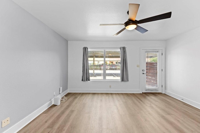 1101 Grove Blvd Unit 803, Austin, TX 78741 - spare room featuring light wood-type flooring, ceiling fan, and baseboards