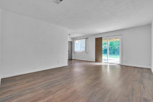 4406 Dove Springs Dr, Austin, TX 78744 - unfurnished room with dark wood finished floors, a textured ceiling, and baseboards