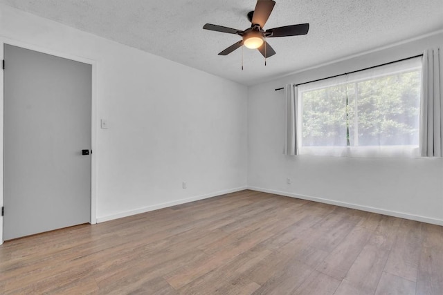 4406 Dove Springs Dr, Austin, TX 78744 - empty room featuring wood finished floors, ceiling fan, a textured ceiling, and baseboards