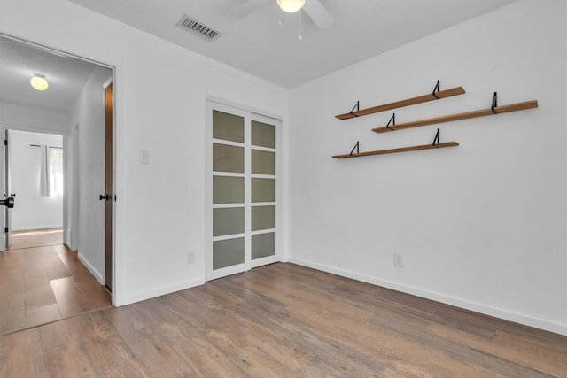 4406 Dove Springs Dr, Austin, TX 78744 - empty room with wood finished floors, a ceiling fan, and baseboards