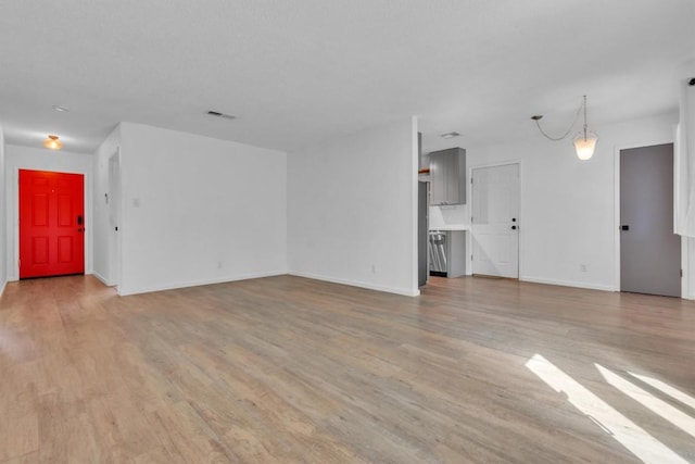 4406 Dove Springs Dr, Austin, TX 78744 - unfurnished living room featuring wood finished floors and baseboards