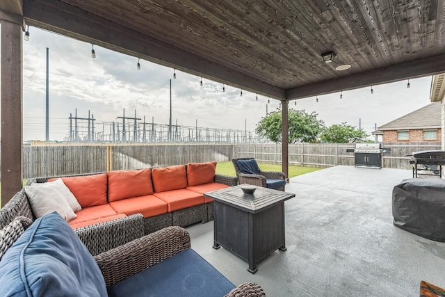 302 Emory Fields Dr, Hutto, TX 78634 - fenced backyard featuring an outdoor hangout area, a grill, and a patio