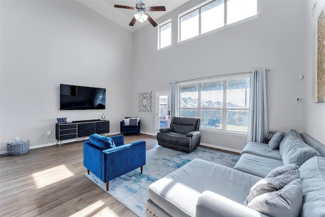 302 Emory Fields Dr, Hutto, TX 78634 - living room featuring high vaulted ceiling, a ceiling fan, wood finished floors, and baseboards