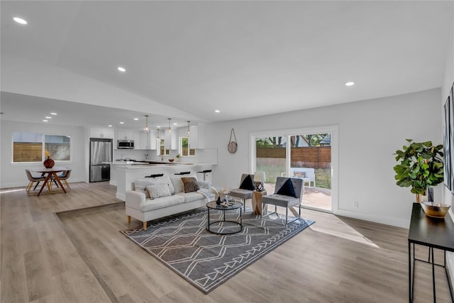 11602 Big Trl, Austin, TX 78759 - living area with light wood-type flooring, recessed lighting, vaulted ceiling, and baseboards