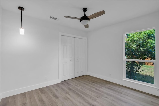 11602 Big Trl, Austin, TX 78759 - unfurnished bedroom featuring light wood-type flooring, baseboards, a closet, and ceiling fan