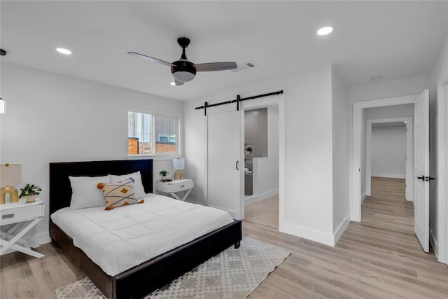 11602 Big Trl, Austin, TX 78759 - bedroom with a barn door, light wood finished floors, baseboards, recessed lighting, and a ceiling fan