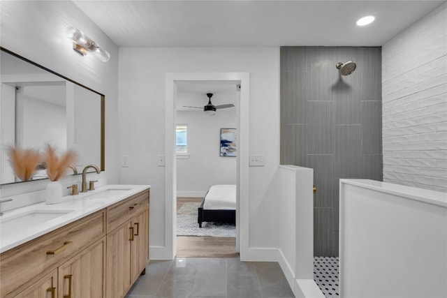 11602 Big Trl, Austin, TX 78759 - bathroom with ensuite bath, double vanity, ceiling fan, walk in shower, and baseboards