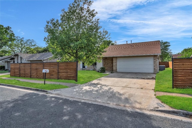 11602 Big Trl, Austin, TX 78759 - view of front of property featuring driveway, a garage, brick siding, and central air condition unit