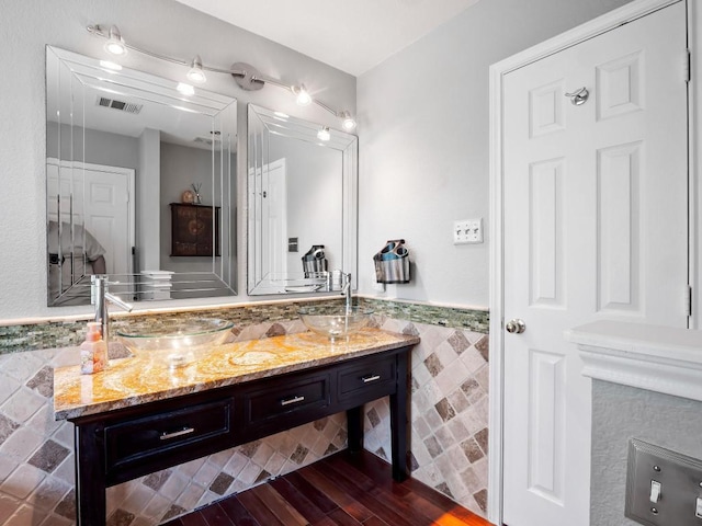 705 Jane Austen Trl Unit B, Pflugerville, TX 78660 - bathroom with tile walls, vanity, wood finished floors, and wainscoting