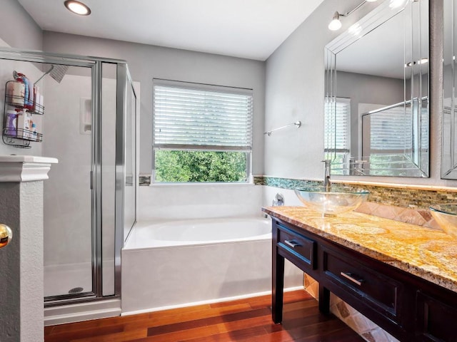 705 Jane Austen Trl Unit B, Pflugerville, TX 78660 - full bath with wood finished floors, a stall shower, a garden tub, and vanity