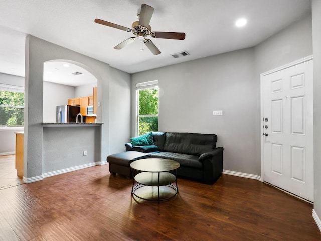 705 Jane Austen Trl Unit B, Pflugerville, TX 78660 - living room with wood finished floors, baseboards, ceiling fan, and arched walkways
