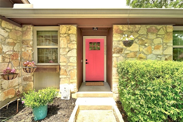 2406 Shiloh Dr, Austin, TX 78745 - doorway to property featuring stone siding and a security system