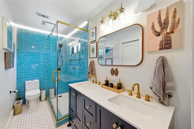 2406 Shiloh Dr, Austin, TX 78745 - bathroom with double vanity, a stall shower, toilet, and tile patterned flooring