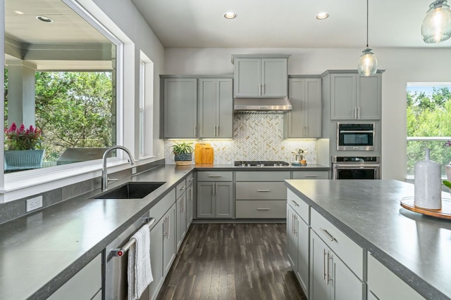 1280 Lucca Dr, Dripping Springs, TX 78620 - kitchen with stainless steel appliances, gray cabinets, a sink, dark countertops, and dark wood-style flooring