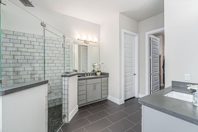 1280 Lucca Dr, Dripping Springs, TX 78620 - full bathroom featuring two vanities, a stall shower, and tile patterned floors