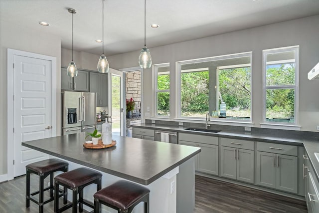 1280 Lucca Dr, Dripping Springs, TX 78620 - kitchen with stainless steel appliances, dark countertops, plenty of natural light, gray cabinets, and recessed lighting