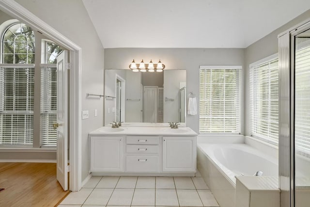 5405 Apache Creek Cv, Austin, TX 78735 - bathroom with plenty of natural light, a bath, double vanity, a stall shower, and vaulted ceiling