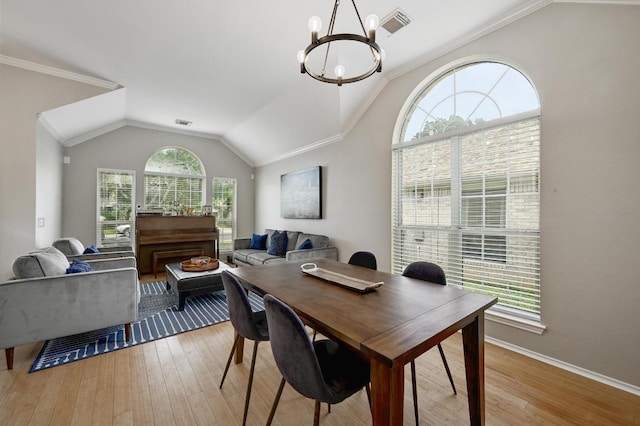 5405 Apache Creek Cv, Austin, TX 78735 - dining room with a chandelier, vaulted ceiling, light wood-style flooring, baseboards, and crown molding