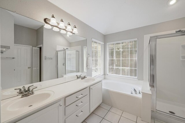 5405 Apache Creek Cv, Austin, TX 78735 - bathroom featuring a stall shower, a garden tub, double vanity, tile patterned floors, and lofted ceiling