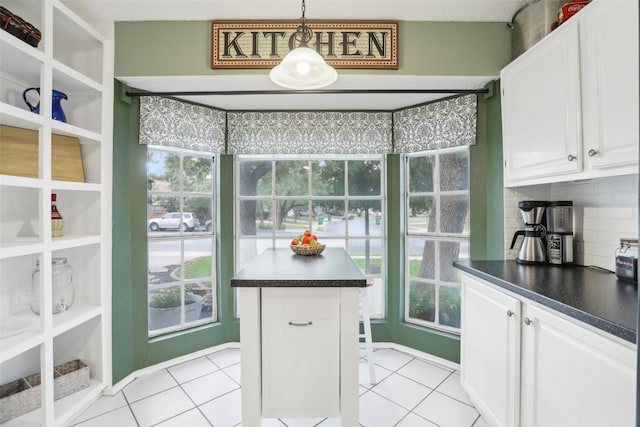 17008 Cactus Blossom Dr, Pflugerville, TX 78660 - kitchen with dark countertops, healthy amount of natural light, and white cabinetry