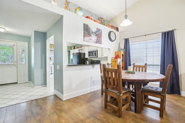 17008 Cactus Blossom Dr, Pflugerville, TX 78660 - dining space with lofted ceiling, wood finished floors, and baseboards