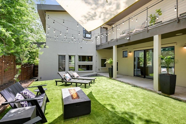 1904 E 9th St, Austin, TX 78702 - back of house with an outdoor fire pit, stucco siding, and a balcony