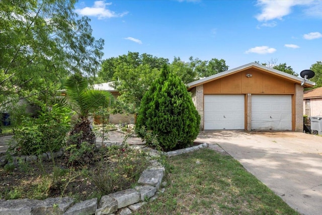 1307 Meadgreen Dr, Austin, TX 78758 - view of front of house with brick siding, a garage, and an outbuilding