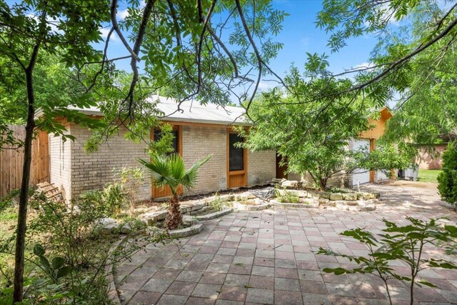1307 Meadgreen Dr, Austin, TX 78758 - view of front of home featuring brick siding and a garage