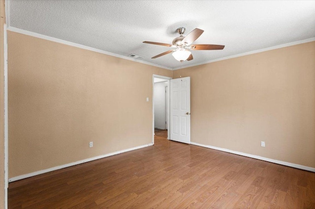 1307 Meadgreen Dr, Austin, TX 78758 - spare room featuring a ceiling fan, wood finished floors, baseboards, and ornamental molding