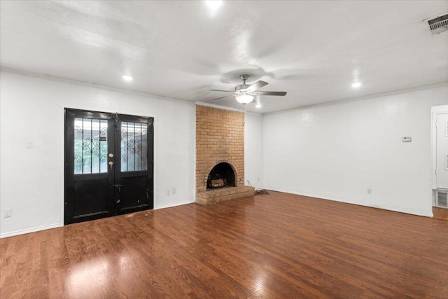 1307 Meadgreen Dr, Austin, TX 78758 - unfurnished living room with wood finished floors, crown molding, french doors, a ceiling fan, and a fireplace