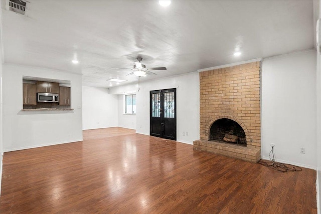 1307 Meadgreen Dr, Austin, TX 78758 - unfurnished living room with a fireplace, wood finished floors, recessed lighting, a ceiling fan, and baseboards