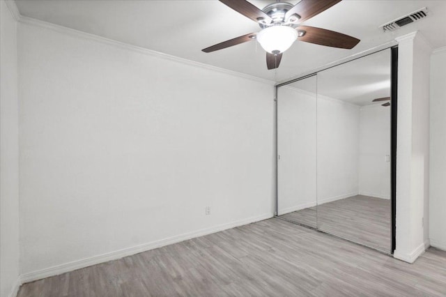 1307 Meadgreen Dr, Austin, TX 78758 - unfurnished bedroom featuring wood finished floors, baseboards, a closet, a ceiling fan, and crown molding